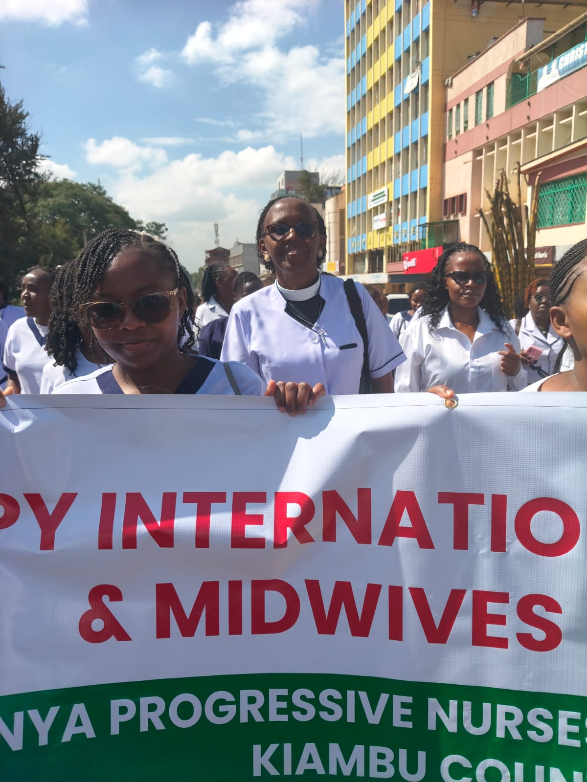 Rev. Irene walking with nursing colleagues during a public gathering