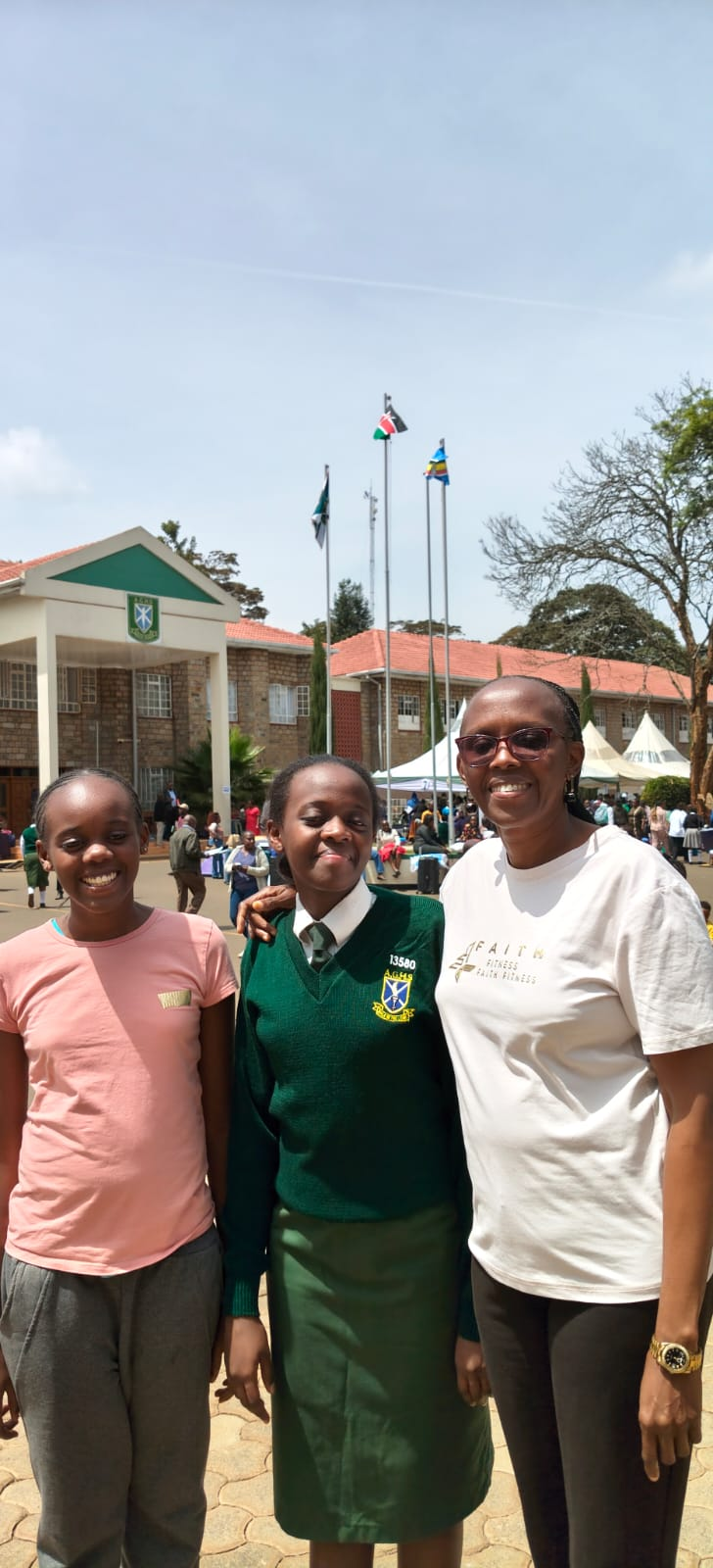 Rev. Irene with two schoolgirls during a school gathering